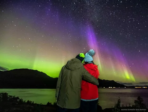 Gids maakt een portret van gasten tijdens de Tromso kleine groep noorderlichtjacht