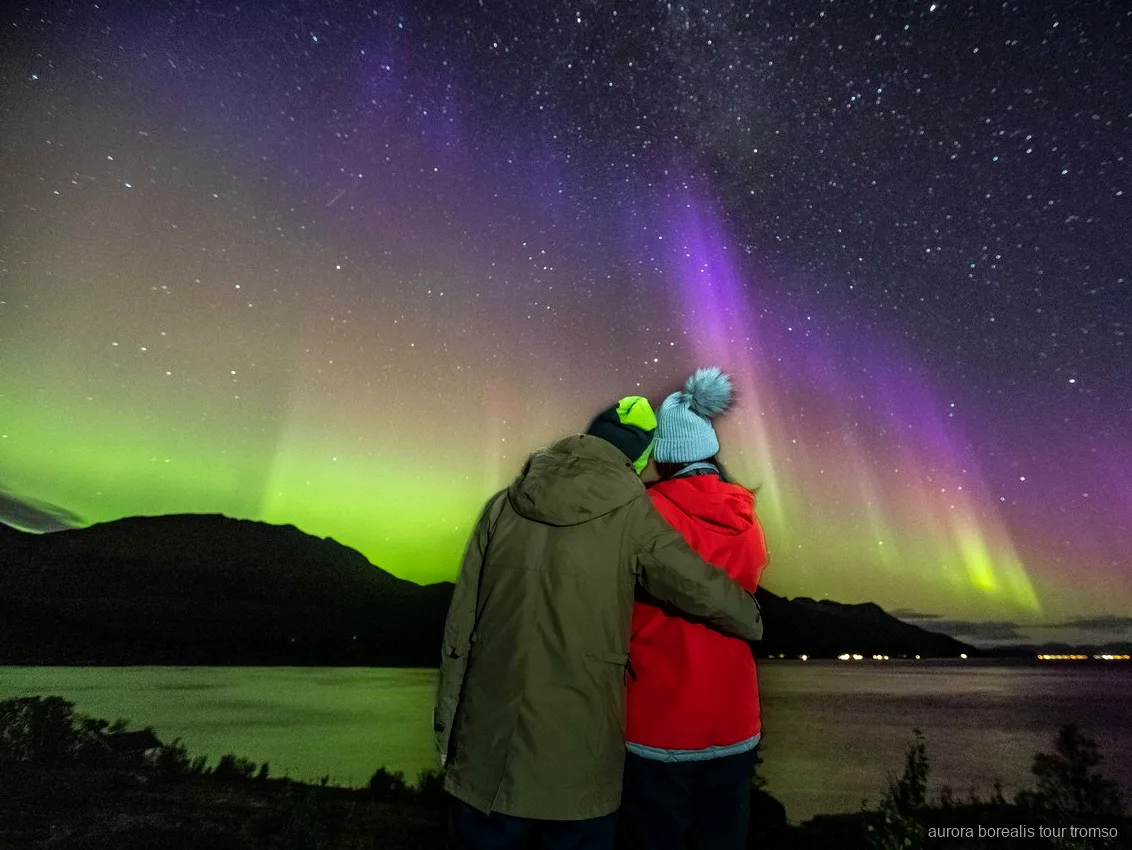 Guide taking a portrait of guests during the Tromso small-group aurora chase